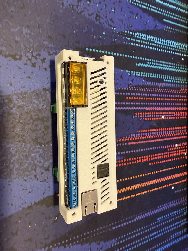 Grey 3D printed case for a Konnected Pro alarm board with red and blue terminal blocks exposed.